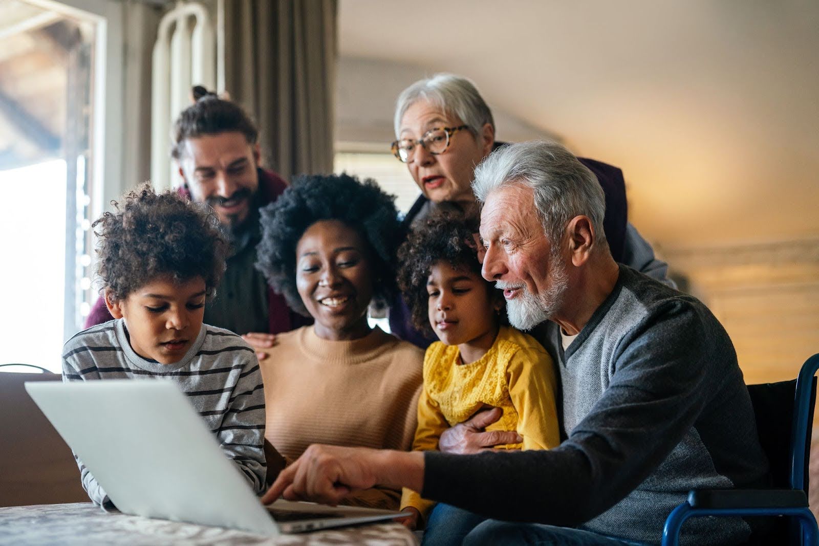 multi-generation family gathering around notebook